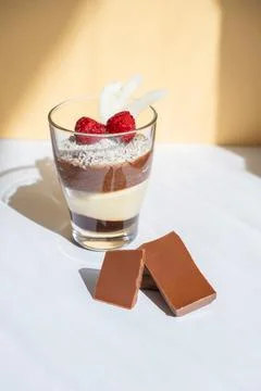 Delicious three-layer mousse, vanilla, chocolate, creme brulee dessert in a Stock Photos
