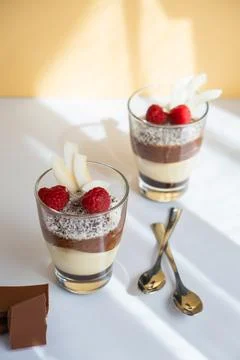 Delicious three-layer mousse, vanilla, chocolate, creme brulee dessert in a Stock Photos