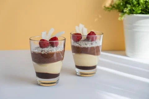 Delicious three-layer mousse, vanilla, chocolate, creme brulee dessert in a Stock Photos
