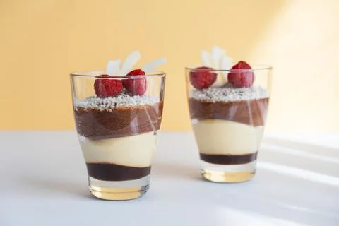 Delicious three-layer mousse, vanilla, chocolate, creme brulee dessert in a Stock Photos