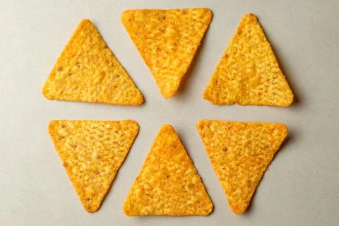 Delicious triangular snack arranged in a playful display on a neutral background 库存照片