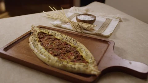 Delicious Turkish pide with minced meat served on a wooden board Stock Footage 345633966