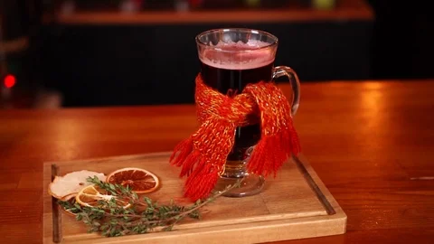 Delicious typical Christmas time alcohol drink mulled wine in funny glass with Stock Footage 103992136
