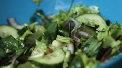Delicious vegetable salad made of fresh tasty green cucumbers, lettuce leaves Stock Footage 61783571