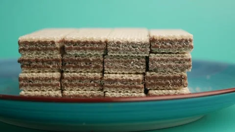 Delicious wafer stack on a vibrant blue plate Stock Footage 322146895
