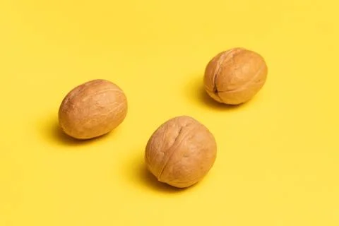 Delicious walnuts on yellow background. Stock Photos