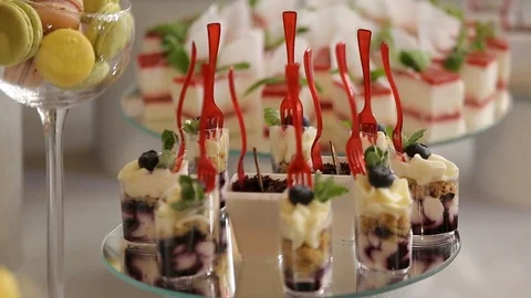 Delicious wedding reception candy bar dessert table inside of the celebration Stock Footage 94388748