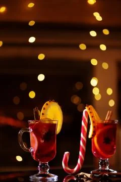 Delicious winter mulled wine with oranges at romantic fireplace 2 Stock Photos
