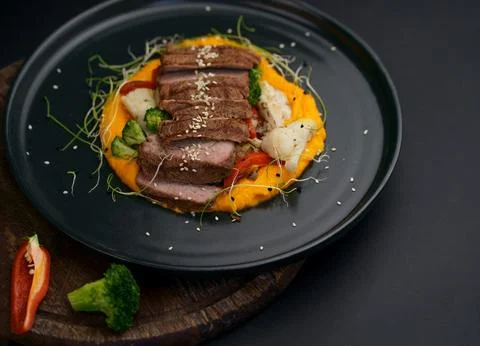 A deliciously appetizing pumpkin puree with chunks of beef meat with spices a Foto stock