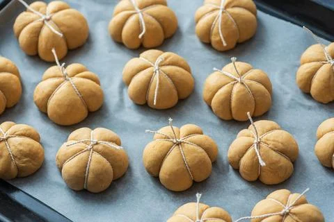 Deliciously crafted pumpkin shaped bread rolls tied with white string on ba.. Stock Photos