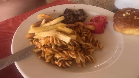 A Deliciously Plated Meal Featuring Twisted Pasta, Tender Beef, Fresh Tomatoes, Video stock 330184878