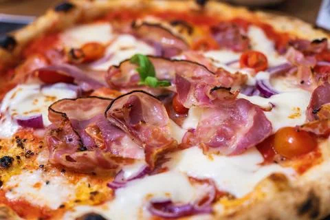 Deliciously prepared prosciutto pizza with fresh ingredients ready to enjoy at a Stock Photos