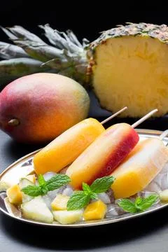 Deliciously refreshing mango pineapple ice cream on a decorative plate with Stock Photos