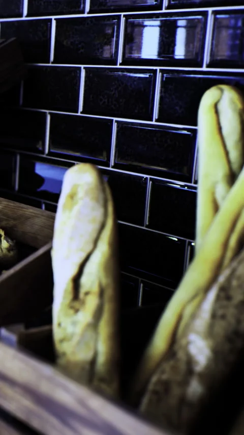 Deliciously twisted breadsticks resting against a glossy backsplash Vídeo Stock 334246945