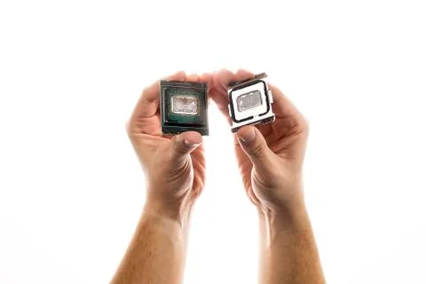Delidded CPU with old thermal paste and glue in man's hand isolated on white Stock Photos