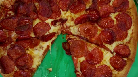 Delight in pepperoni pizza slices held by hands. A flavorful moment captured 動画素材 258965401