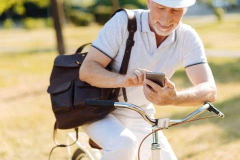 Delighted bearded man using his telephone Foto stock