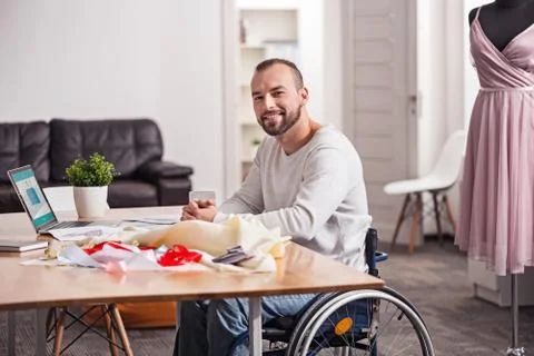 Delighted creative tailor in his home studio Stock Photos