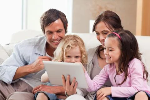 Delighted family using a tablet computer Foto stock