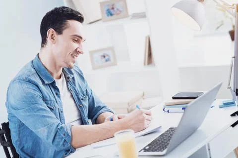 Delighted freelancer working at home 写真素材