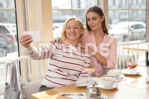 Delighted granny and girl taking selfies Stock Photos