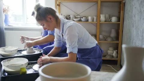 Delighted guy and lady work with clay on pottery machines Stock Footage 162492544