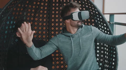 Delighted homosexual couple testing the virtual reality glasses at home. Man Stock Footage 145260923