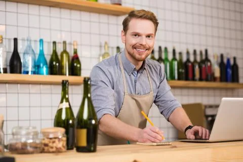 Delighted nice man taking notes Stock Photos