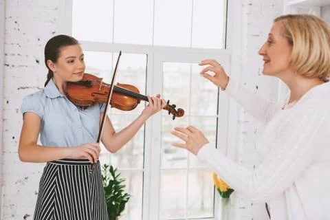 Delighted tutor raising her hands Stock Photos
