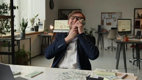Delighted Young Man Flipping through Stack of Money and Kissing It with Smile Stock Footage 331533699