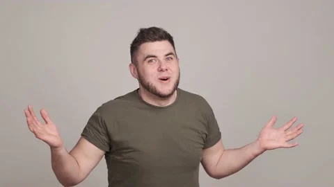 Delighted young man making emotional gestures on grey background Stock Footage 160964910