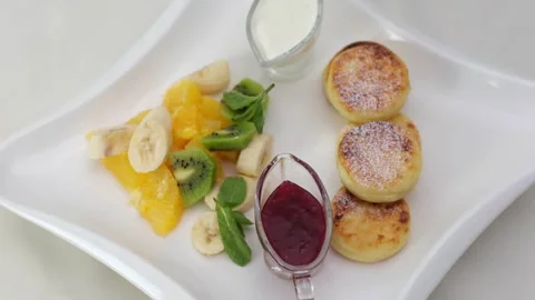 A Delightful and Delicious Pancake Stack Topped with Fresh Seasonal Fruits and 스톡 동영상 326494157