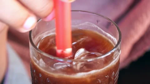 A delightful and refreshing iced beverage served in a clear glass with a Vidéo 293415323