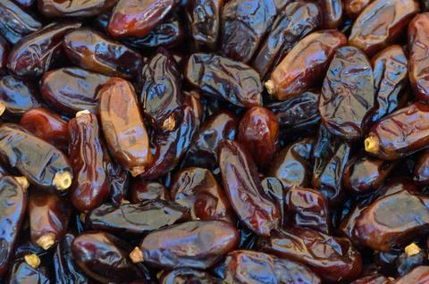 Delightful array of dates showcasing rich colors and textures in a bustling.. Fotos de archivo