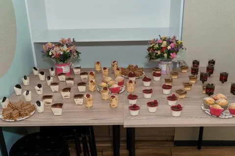 Delightful Dessert Table Featuring an Array of Sweet Treats and Floral Arrang Fotos de archivo