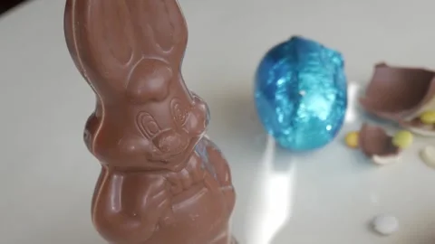 Delightful Easter Chocolate Bunny and Colorful Eggs Closeup Stock Footage 332943850