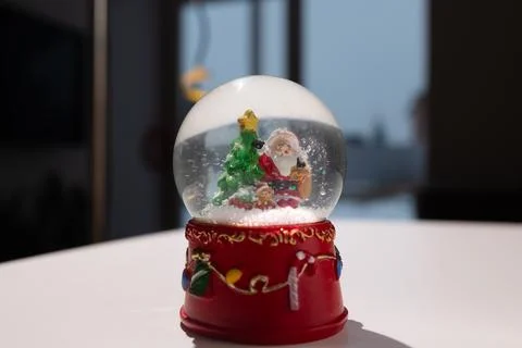 A delightful, festive snow globe featuring Santa along with beautiful Christmas Stock Photos
