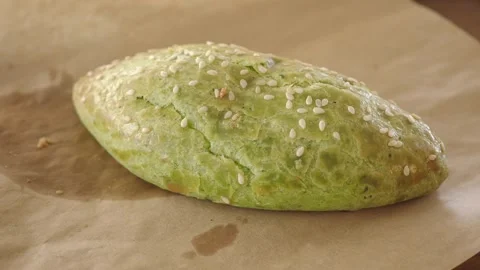 Delightful green bread creation in a cozy kitchen setting Stock Footage 339121797