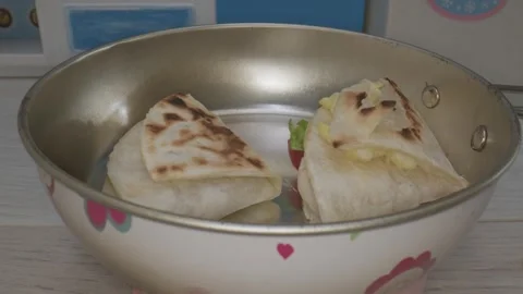 In a delightful miniature kitchen someone is preparing food using tiny cookware Video stock 286893460