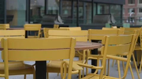Delightful Outdoor Cafe Setting Featuring Bright and Charming Yellow Furniture Vídeo Stock 295075429