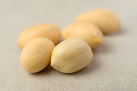 Delightful peanuts scattered on a smooth surface ready for snacking Stock Photos