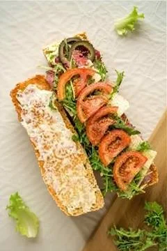 A delightful Rice Cake Sandwich with sliced Tomato, Cheese, and Olives Stock Photos