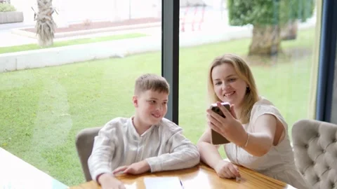 A delightful video call between a joyful mom and her adorable son at home Stock Footage 316980525