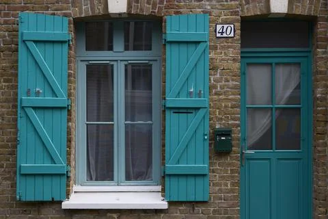 A Delightfully Charming Turquoise Window and Door Set Against a Beautiful B.. Stock Photos