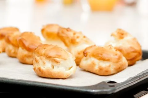 Delisious profiteroles on the baking tray Stock Photos
