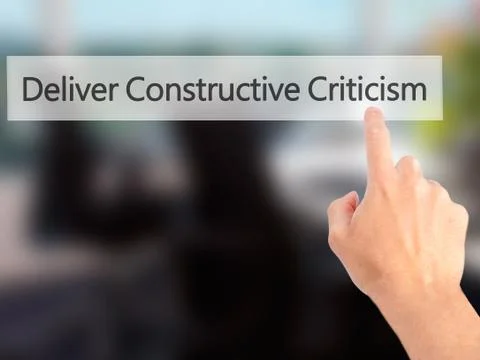 Deliver Constructive Criticism - Hand pressing a button on blurred background Stock Photos