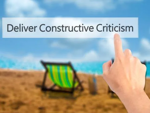 Deliver Constructive Criticism - Hand pressing a button on blurred background Stock Photos