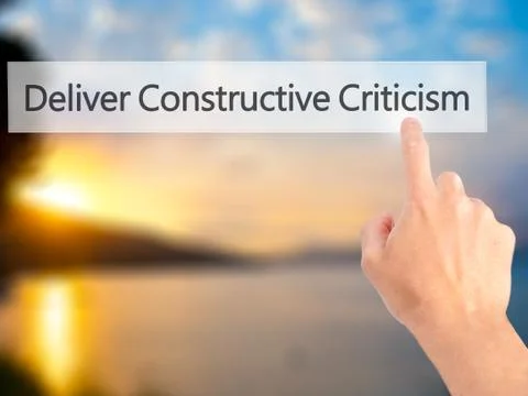 Deliver Constructive Criticism - Hand pressing a button on blurred background Stock Photos