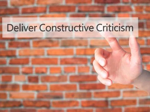 Deliver Constructive Criticism - Hand pressing a button on blurred background Stock Photos