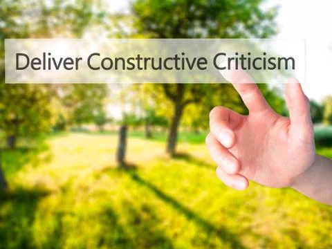 Deliver Constructive Criticism - Hand pressing a button on blurred background Foto stock